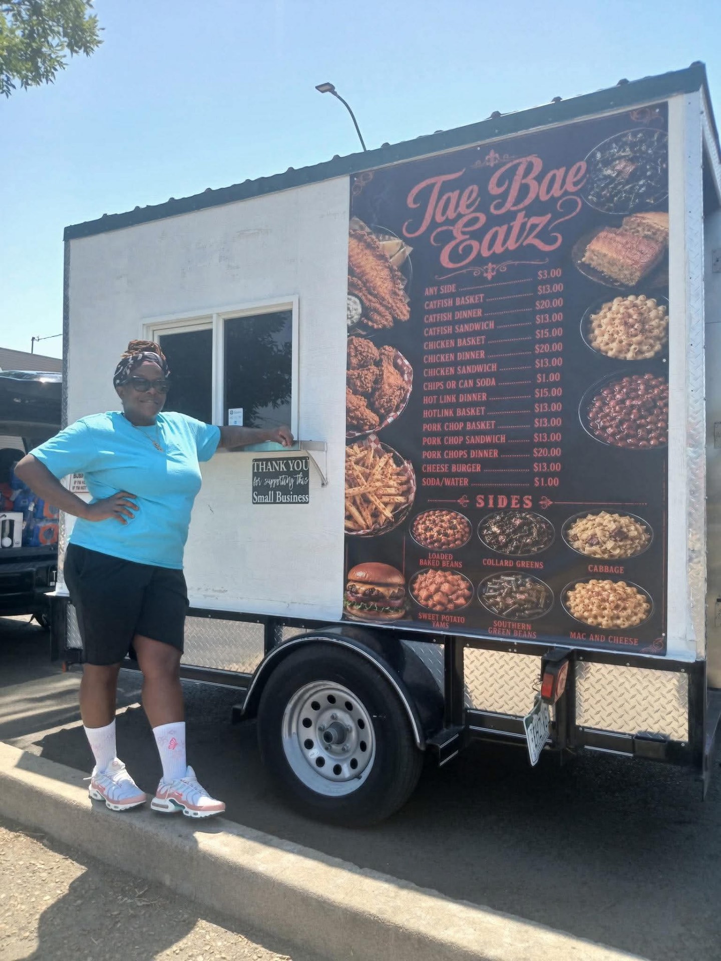 The Tae Bae Eatz food truck with its owner standing by the service window